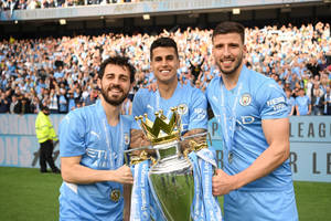 Ruben Dias With His Teammates Holding Trophy Wallpaper