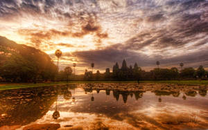 Ruins Of Angkor Wat Below Majestic Sunset Sky Wallpaper