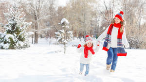 Running Mother And Daughter In Snow Wallpaper