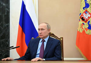 Russian President Vladimir Putin Exhibits A Calm Demeanor Wallpaper