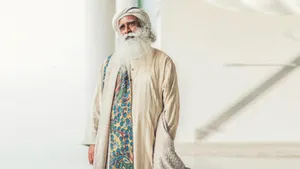 Sadhguru Standing On A White Hall Wallpaper