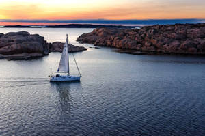 Sailing On Seas With Rock Formation Wallpaper