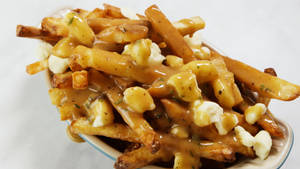 Savory Poutine Platter With Gravy And Fries Wallpaper