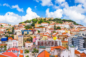 Scenic View Of Hilltop Houses At Sunset In Lisbon, Portugal Wallpaper