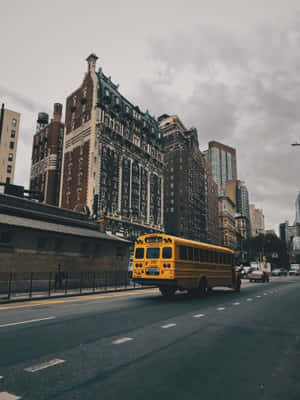 School Bus Against Tall Buildings Wallpaper