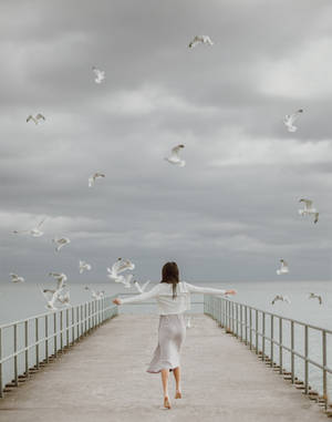 Seagull Birds Flying Over A Woman Wallpaper