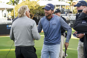 Sean O'hair Shakes Hands With Greg Norman Wallpaper