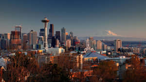 Seattle Skyline At Sunset With Mt Mccall In The Background Wallpaper