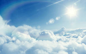 Serene Blue Skies With Bright, Cottony Clouds Wallpaper