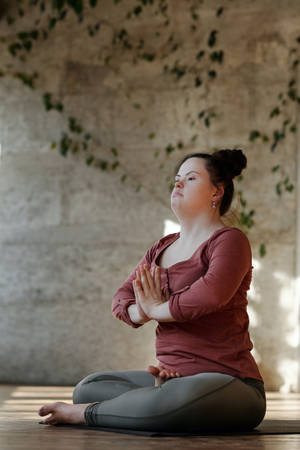 Serenity Redefined: A Girl Meditating In Solitude Wallpaper