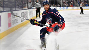 Seth Jones Gliding On Rink And Splashing Ice Wallpaper