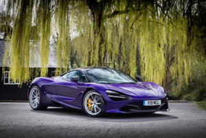 Showcasing Power And Luxury: The Stunning Mclaren 720s In Violet Wallpaper