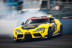 Showing Off Its Powersliding Style, This Supra Drift Is Ready To Hit The Track. Wallpaper