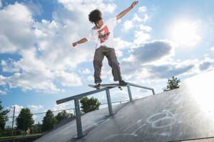 Shredding The Street: An Urban Skateboarder In Action Wallpaper