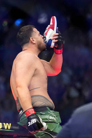 Side Photo Of Tai Tuivasa Drinking From Shoe Wallpaper