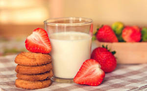 Sidetrack Your Cravings With A Nutritious Combo Of Milk, Cookies, And Strawberries Wallpaper