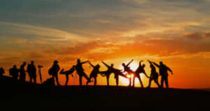 Silhouette Of Group Of Friends During Sunset Wallpaper