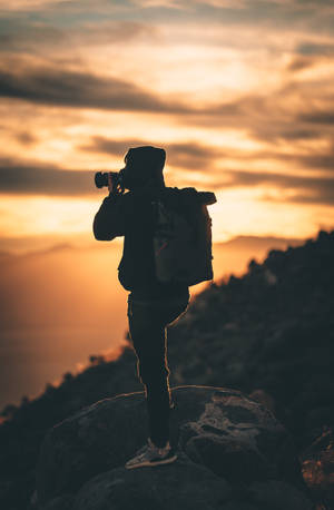 Silhouette Of Man Holding Camera During Sunset Photography Wallpaper