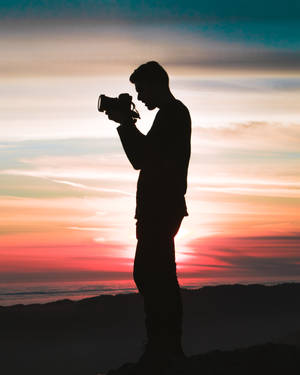 Silhouette Of Man Taking Sunset Photography Wallpaper