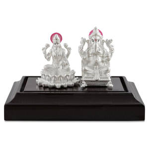 Silver Figurines Of Ganesh Lakshmi Wallpaper