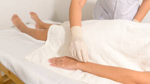 Skilled Acupuncturist Performing Needle Insertion Wallpaper