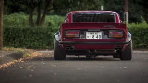 Sleek And Stylish Datsun On The Road Wallpaper