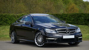 Sleek Black Mercedes Coupe Parked Outdoors Wallpaper