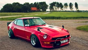 Sleek Datsun Drifting Along A Coastline Wallpaper