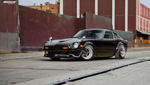 Sleek Datsun Sports Car On An Open Road Wallpaper