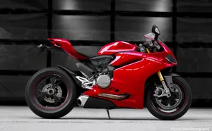 Sleek Red Ducati 1299 Panigale In An Urban Setting Wallpaper