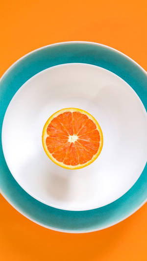 Sliced Orange Fruit On Plate Wallpaper