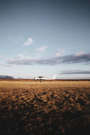 Small Airplane On Grassland Wallpaper