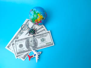 Small Plane Beside Dollar Bills & Globe Wallpaper