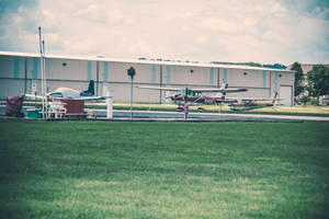 Small Plane On Grass Wallpaper