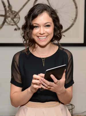 Smiling Woman Holding Tablet Wallpaper