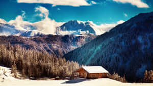 Snow Covered Cabin In The Mountain Wallpaper
