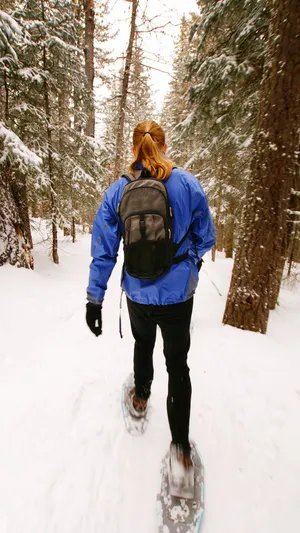 Snowshoeing In The Snow Mountain Wallpaper