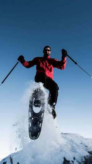 Snowshoeing Jump Pose Wallpaper