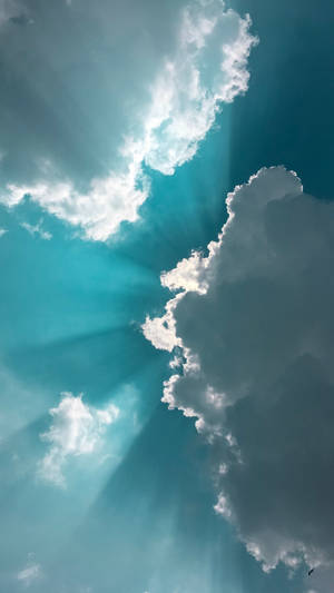 Soft, Turquoise Clouds In A Bright, Blue Sky Wallpaper