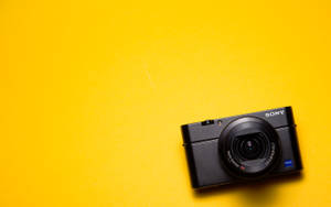 Sony Dslr Camera On Yellow Wallpaper