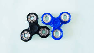 Soothing Design: Black And Blue Fidget Toys Wallpaper