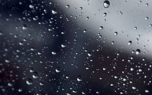 Sparse Raindrops On A Smooth Glass Surface Wallpaper