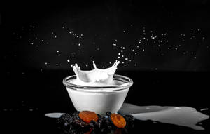 Spilt Milk Splash Captured In Glass Bowl Wallpaper