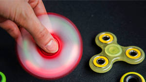 Spinning Red Fidget Toy Wallpaper