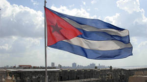 Splendor Of Cuban Flag Waving Under Daylight Wallpaper