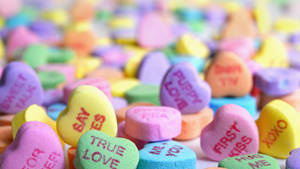 Spread The Love This Season With Colorful Pastel Candy Hearts Wallpaper