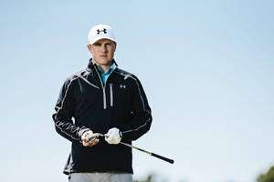 Squinting Jordan Spieth In Black Jacket Wallpaper