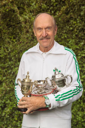 Stan Smith Holding His Trophies Wallpaper