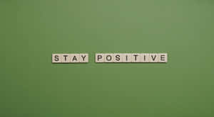 Stay Positive Scrabble Word On Green Background Wallpaper