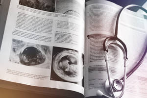 Stethoscope On Top Of Medical Book Wallpaper